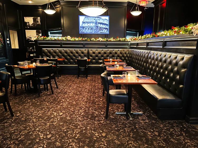 tufted black booths in steakhouse setting