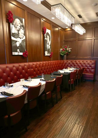 steakhouse dining room red tufted booths and matched red upholstered chairs
